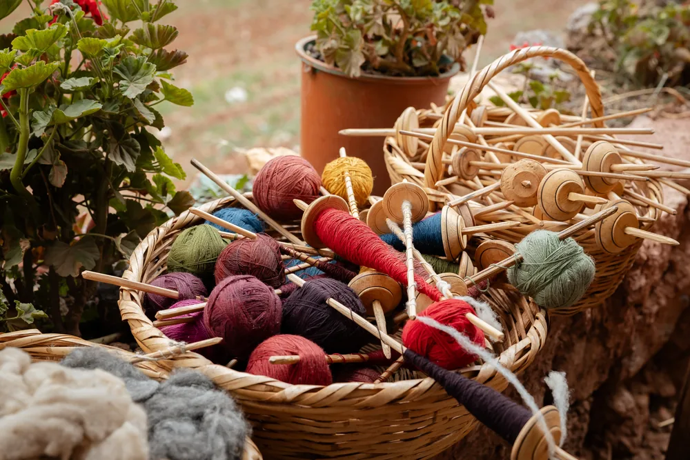 Naturally dyed wool yarn on traditional drop spindles